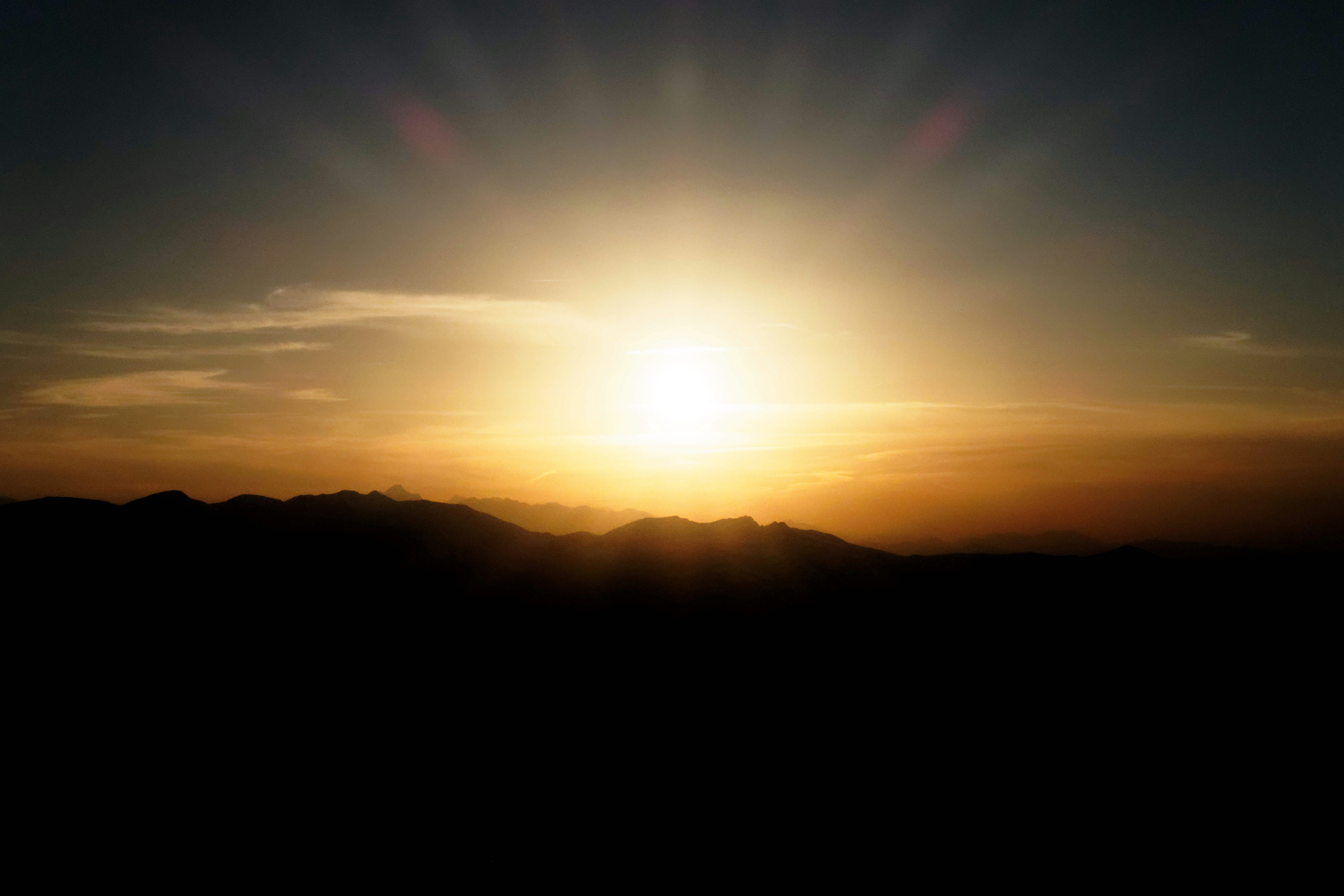 silhouette photography of mountain during golden hour